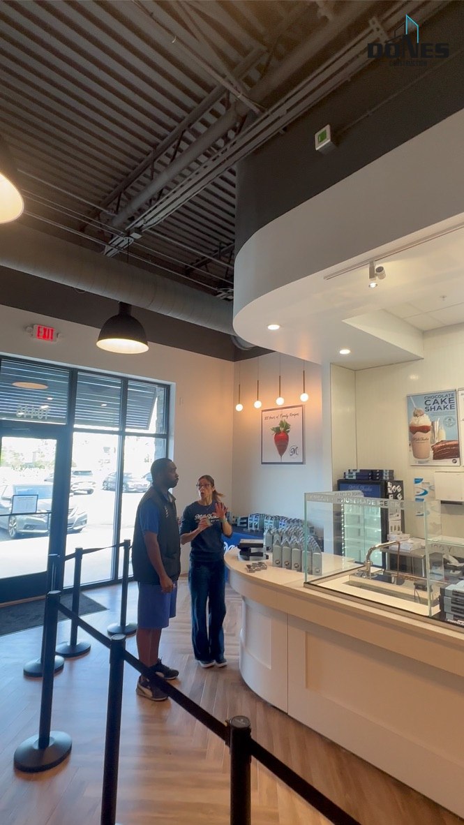 View toward the Milkshake Factory entrance with a curved soffit and exposed ceiling systems