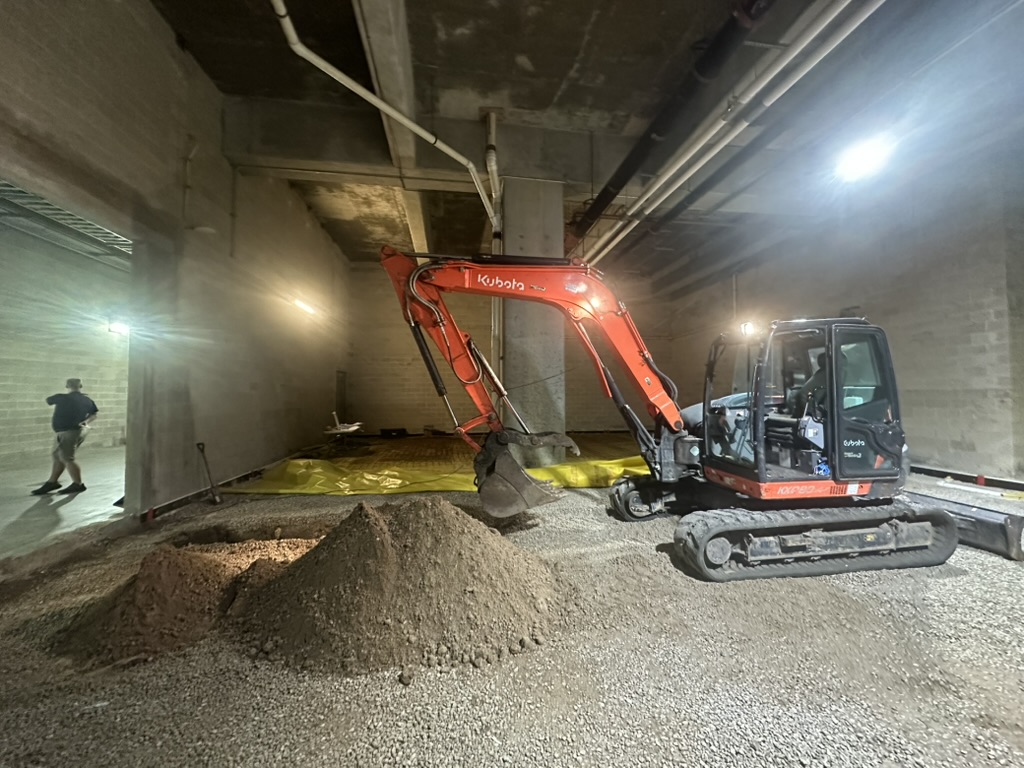 Compact excavator performing interior excavation at Raymond James Stadium