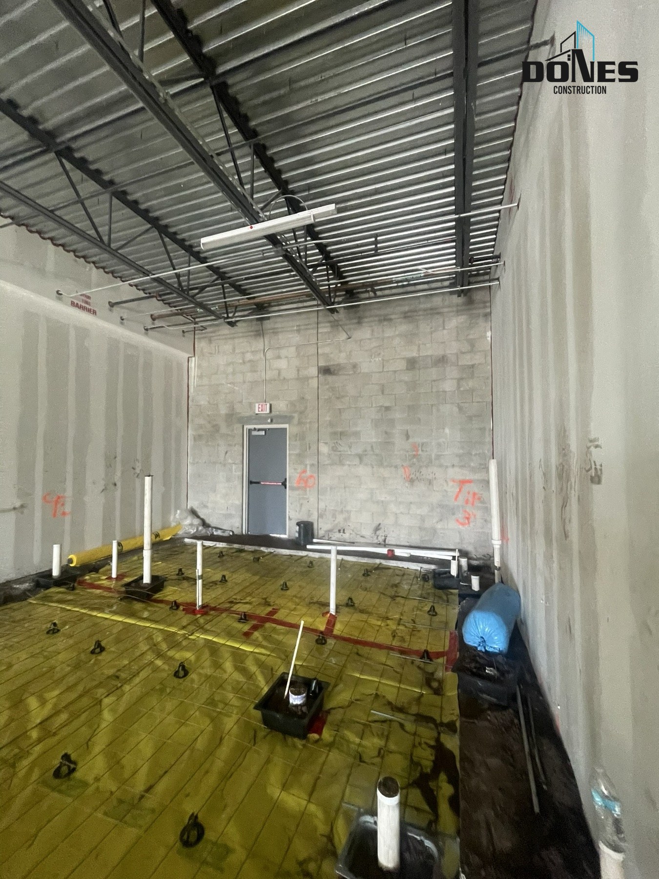 Below-slab plumbing rough-in and vapor barrier in the Wing Snob restaurant