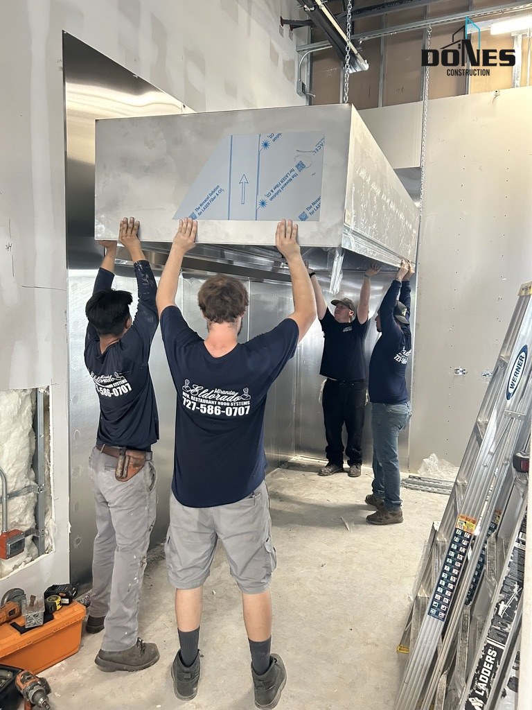Crew installing the commercial kitchen hood at Wing Snob