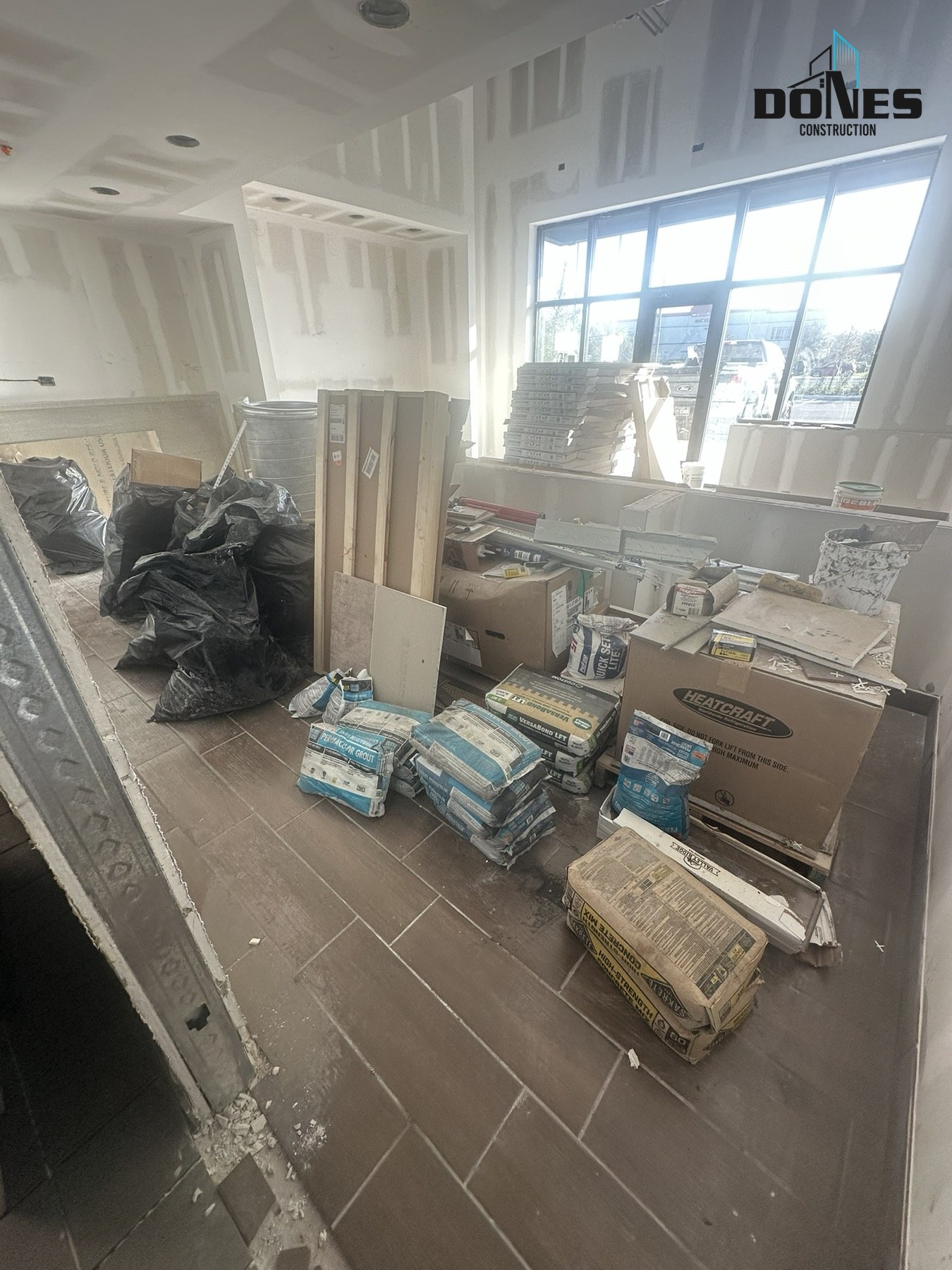 Floor tile and drywall finish work in the Wing Snob dining area